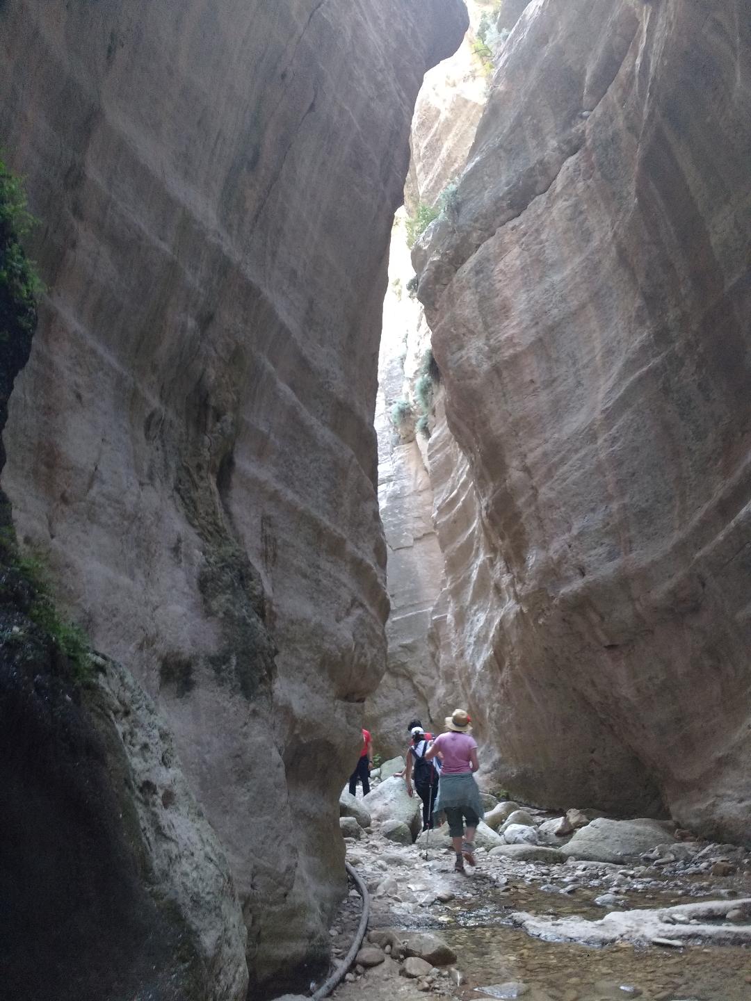 A number of walkers inside a narrow limestone gorge