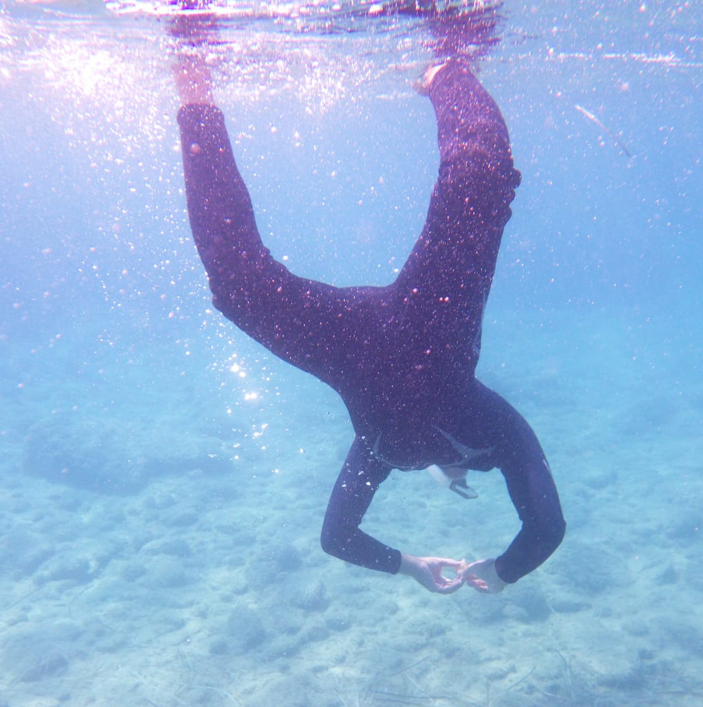 A snorkeller in a wetsuit underwater