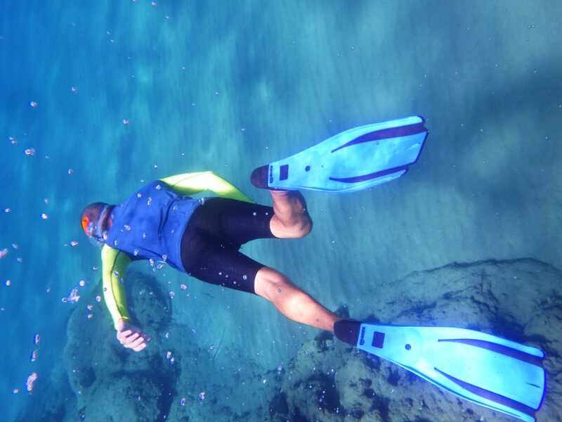 A snorkeler diving