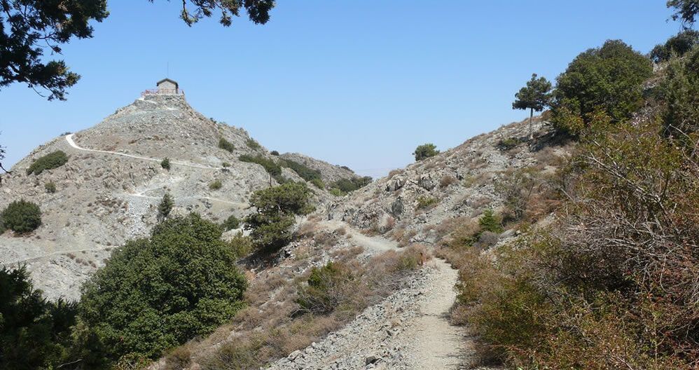 A walking trail and a barren peak with a fire watchtower