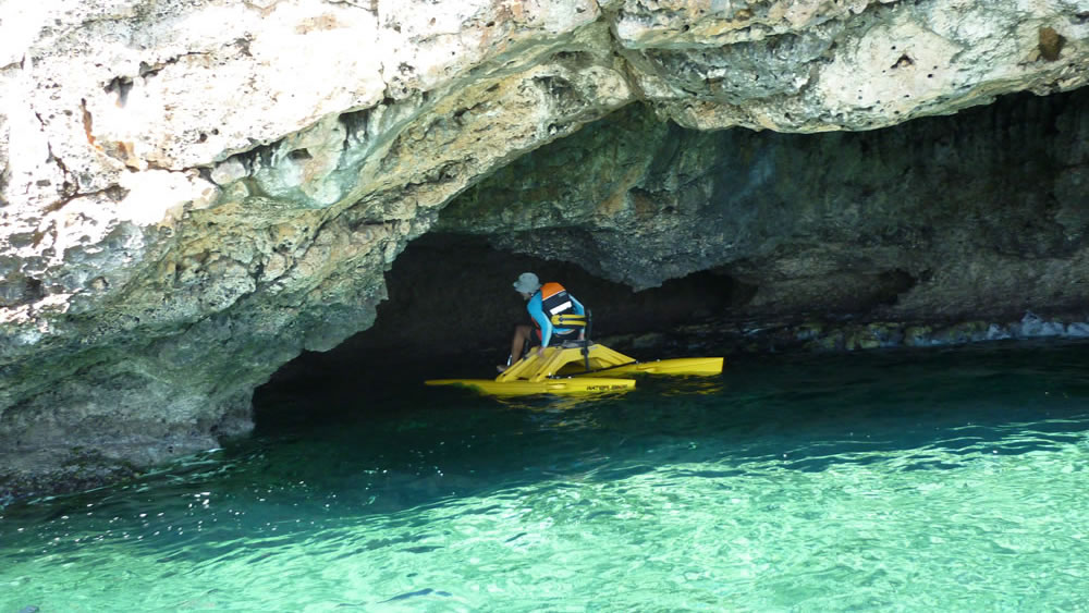 A waterbiker on a waterbike entering a sea cave